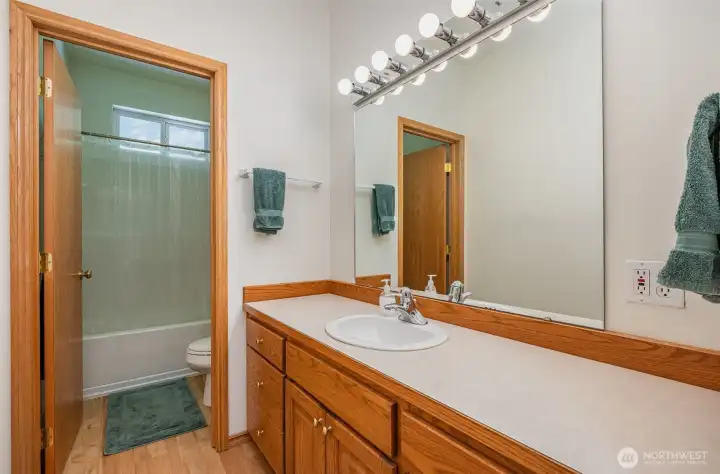 Guest bathroom with tons of cabinet storage and counterspace.