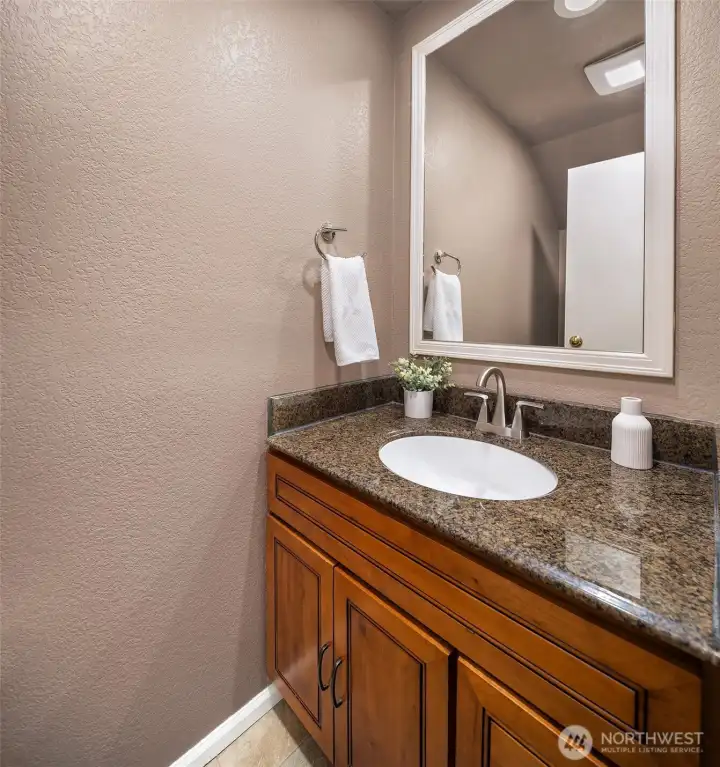Powder room with granite counter.  Fan and faucet are both less than 3 years old