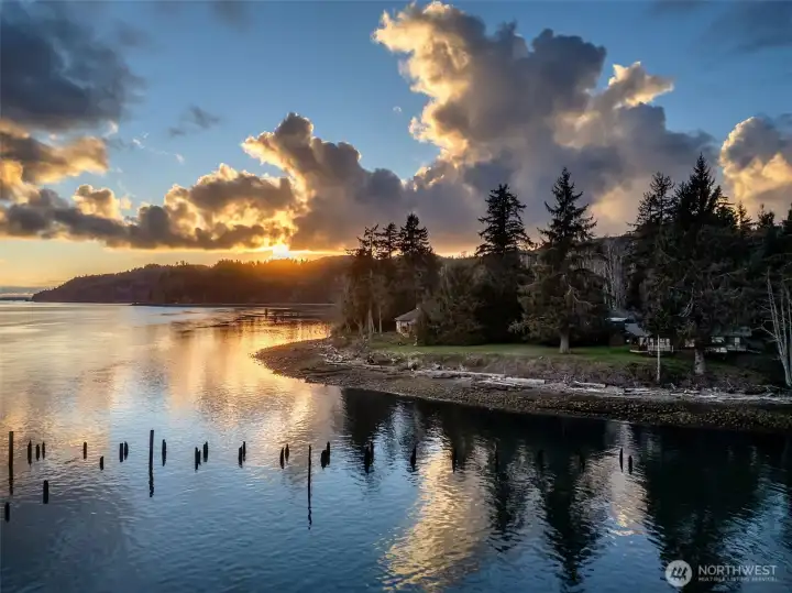 As the sun sets over the ocean to the west