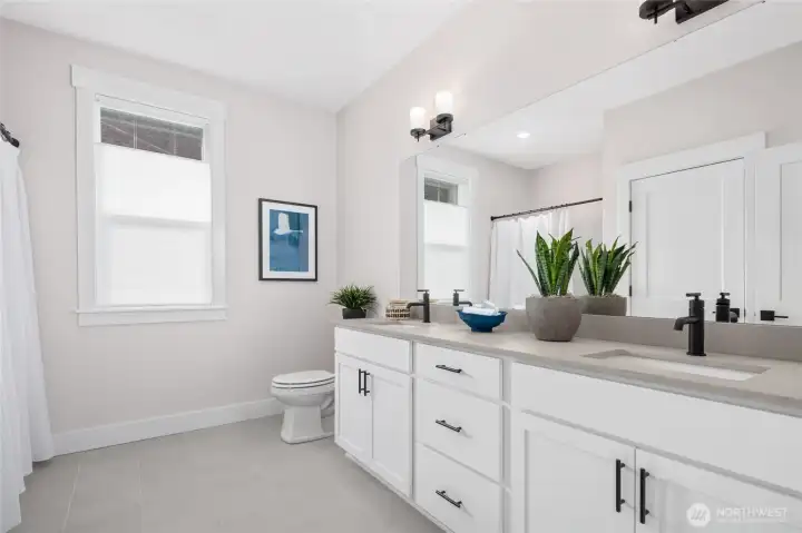 Main bath w/qtz counters, dual sinks, tile floor and tub/shower combo.  All pictures are of actual home.