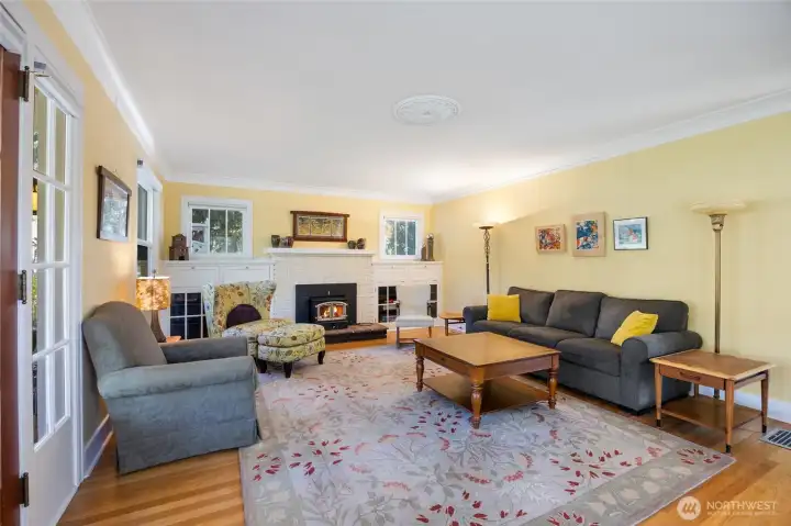 living room with built ins around wood stove, lots of light