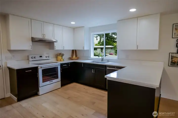 The kitchen boasts newer appliances and a lovely updated kitchen with quartz counter tops.