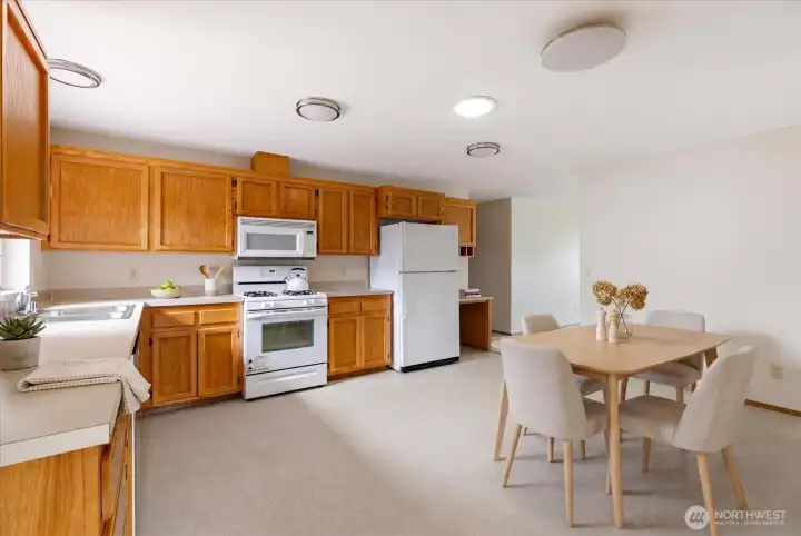 Massive kitchen with greenhouse window, desk station, pantry, extra space for a breakfast table, and lots of room for all the cooks in the kitchen.