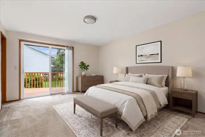 Generous primary bedroom with double closets, ensuite bathroom, and slider to back deck.
