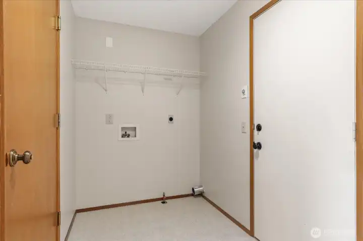 Dedicated laundry room with access to garage and back deck.