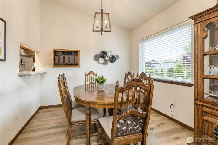 Dining room includes a convenient pass-through window to the kitchen.