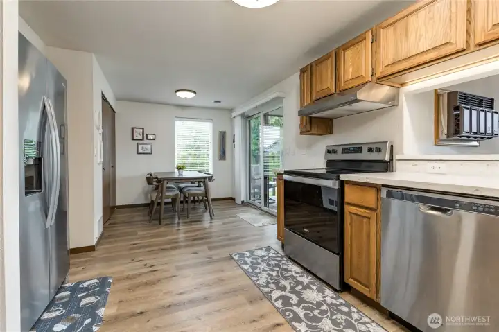 Kitchen flows to the breakfast nook and laundry closet.