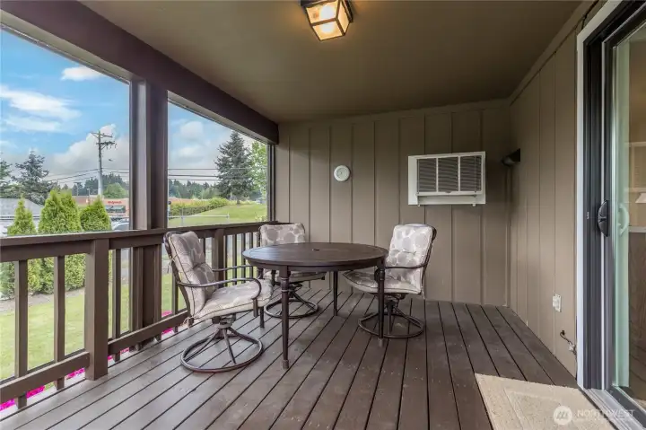 Rain or shine! The covered back deck features a custom plexiglass windbreak, providing a cozy, sheltered space to enjoy the outdoors all year long.