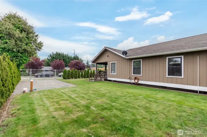 Your private outdoor sanctuary. Plenty of room to play or relax in this sunny, level, and fully-fenced backyard.