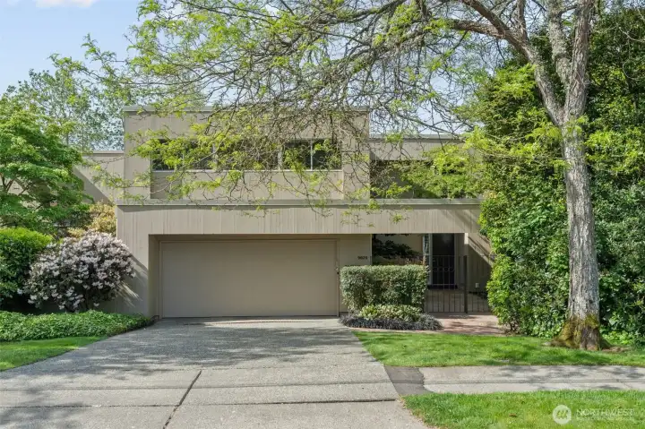 Tucked into one of Lochleven's most private lots, 9829 NE 1st presents a clean, modern profile framed by mature trees and blooming rhododendrons. What you can't see from the street is the $1.1 million gut renovation completed in 2017 — new roof, new siding, every system replaced. The understated exterior is the quiet confidence of a home that has nothing to prove.