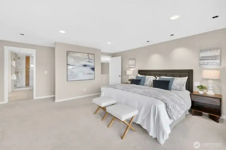 The suite's full footprint comes into view here — a true retreat with room to breathe, the ensuite bath visible through the door on the left with its steam shower and designer tile, and the California Closets system tucked just beyond.