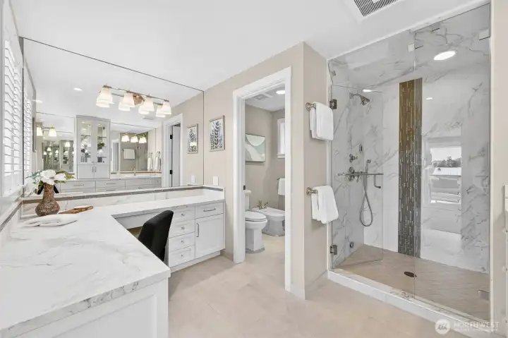 Primary Ensuite features floor-to-ceiling Calacatta marble lines the frameless glass steam shower, setting the tone for a bathroom that was designed without compromise. A private water closet with bidet sits just beyond, while the dedicated makeup vanity with wraparound Dekton counters adds a layer of practicality that matches the room's elegance. Every fixture, tile, and finish was installed new in the 2017 renovation — this is not a bathroom that was refreshed, it was built.