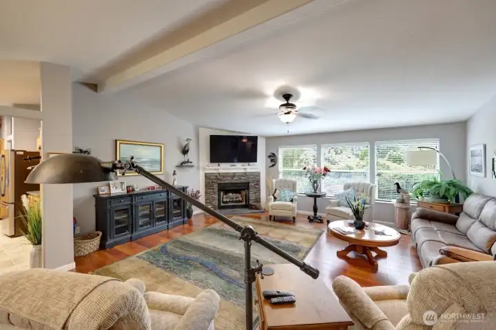 Living room with vaulted ceiling and view of private backyard