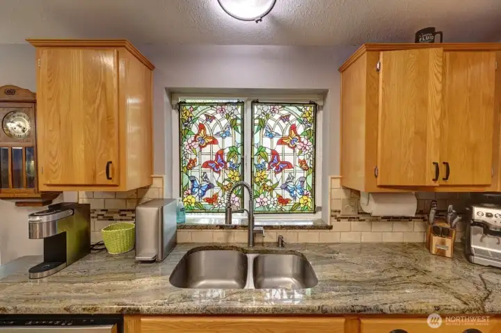 Bright stained glass panels over the kitchen windows