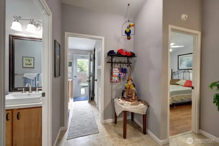 Door to backyard; main bathroom to the left and bedroom #3 on the right