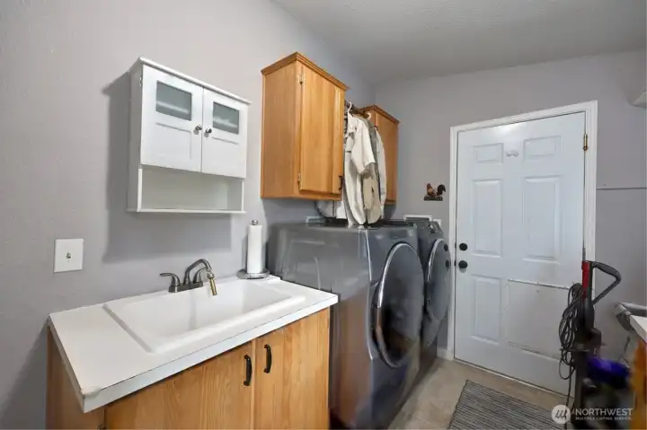 Laundry equipped with washer, dryer, and deep sink