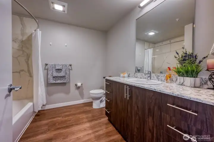 Custom tile shower and plenty of counter space elevate the bathroom Custom tile shower and plenty of counter space elevate the bathroom