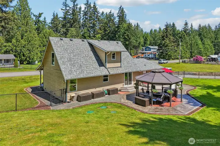 Back yard oasis with a beautiful gazebo which sits on stamped concrete