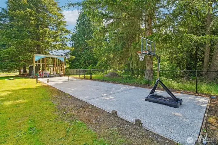 Large sports court. Used to be a batting cage, which could be revived. Pickeball?