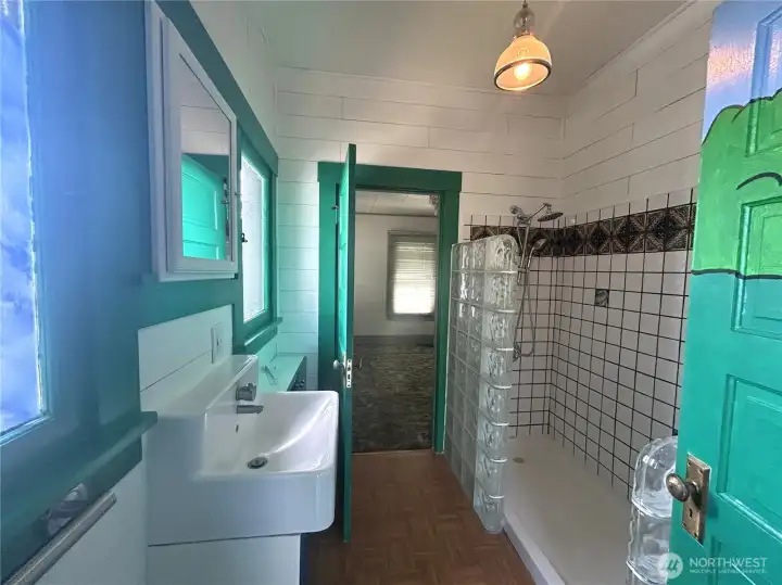 Cute bathroom with built in storage. Bathroom passes through to primary bedroom for convenient access.