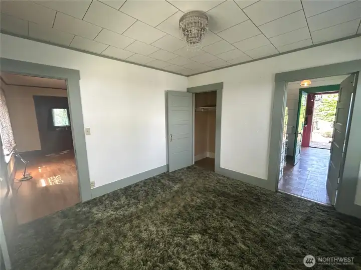 Primary bedroom with access to bathroom on the right, and living room on the left.