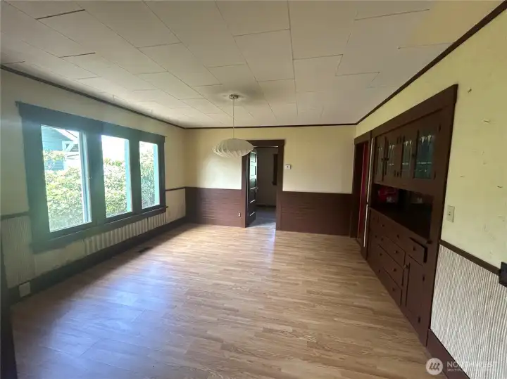 Dining room featuring lovely built in cabinetry and yes, more large windows! The natural lighting throughout this entire home is unbeatable! Storage/coat closet on the left out of view.
