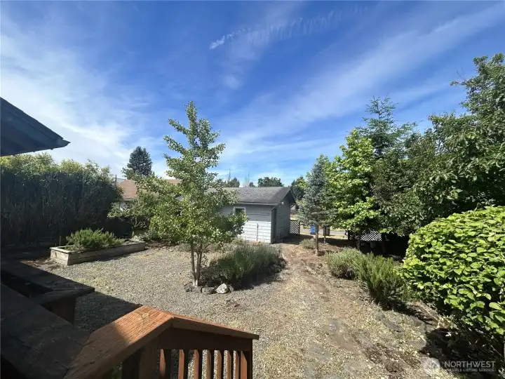 View of low maintenance back yard from deck. Off street parking available behind detached garage, too!