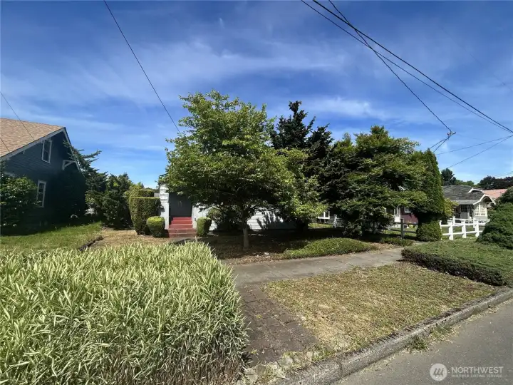 Front yard view from Euclid Way. Mature trees offer shade and privacy.