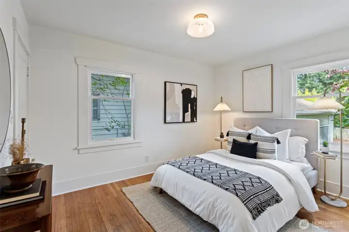 Bedroom on the main floor with new overhead light, walk in closet and light pouring in through two directions.