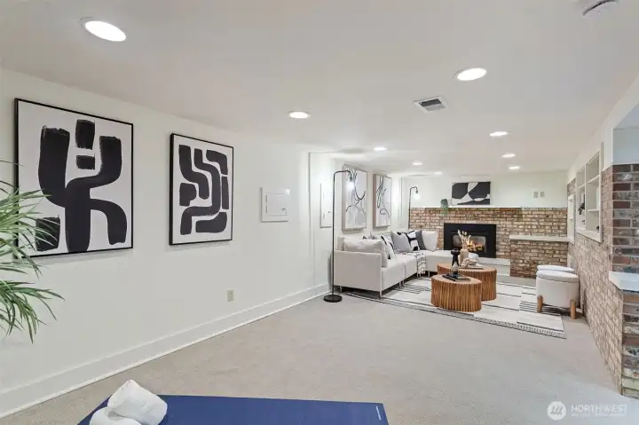 Downstairs bonus/rec room with exposed brick and built in bookcases and cozy gas fireplace.