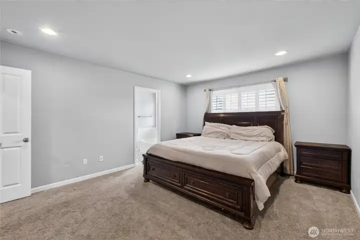 Primary bedroom has custom plantation blinds as well. Primary bedroom has custom plantation blinds as well.