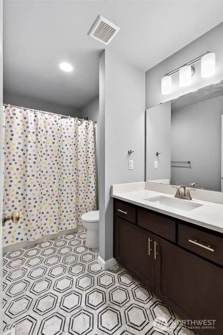 Full hall bath upstairs with tile flooring and quartz counter tops. Full hall bath upstairs with tile flooring and quartz counter tops.