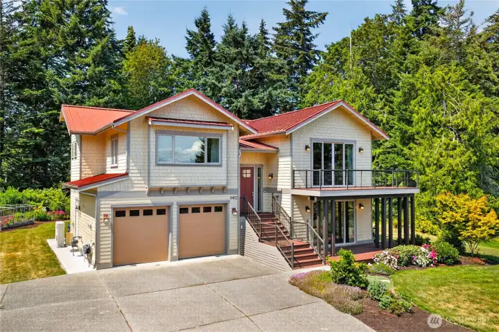 Beautifully crafted Northwest-style home showcases striking architecture, a welcoming covered entry, expansive outdoor living spaces, and professionally landscaped grounds in a serene, park-like setting.