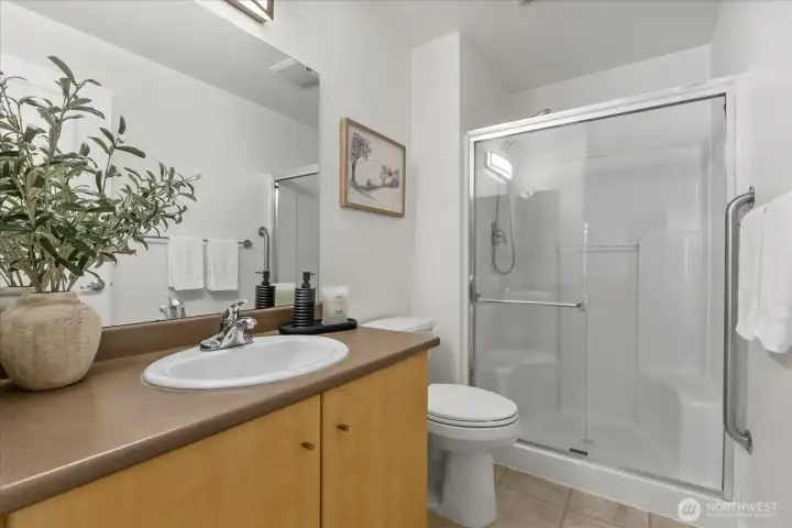 Bright and cheery primary bath with glass shower enclosure. Bright and cheery primary bath with glass shower enclosure.