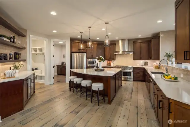 Beautifully appointed chef's kitchen includes breakfast bar seating, extensive countertop and storage space as well as deluxe appliance package