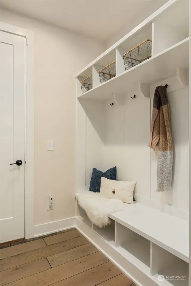 Convenient drop zone between the garage and kitchen is the perfect space to keep shoes, coats and backpacks organized as you come and go