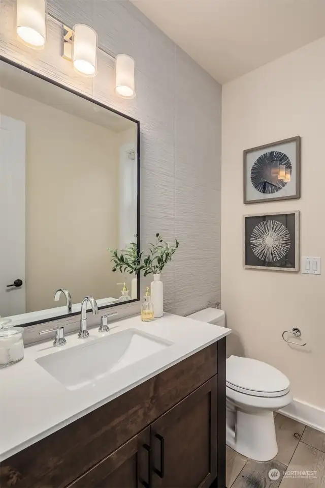 Main floor powder bath complete with tile accent wall