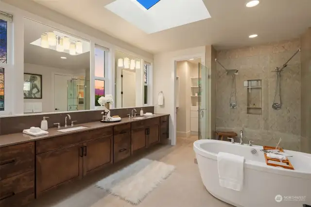 A true spa-inspired bath offers expansive vanity space, freestanding tub and double head shower