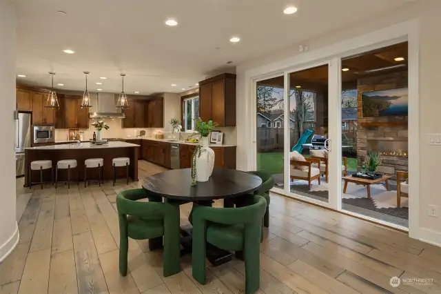 Breakfast nook is nestled between the family room and kitchen. Sliding glass doors lead to the covered patio and fully fenced yard