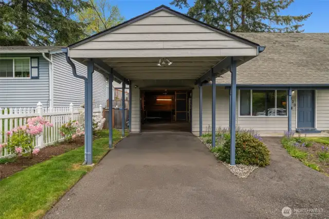 Roomy garage with carport and room for longer vehicles.