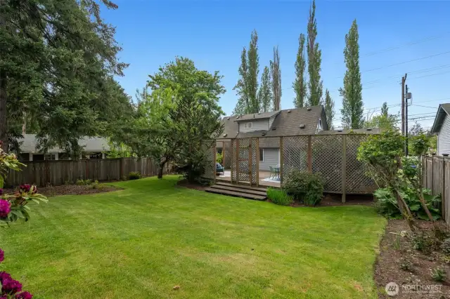 Beyond the perfect entertaing deck is this deep, fully-fenced backyard - room for sport or play of all sorts, for fiddo, for veggie gardens, of even a entire fruit orchard!  Or just enjoy the lush, green, shady space...