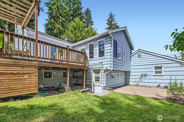Another view of the backyard. Separate patio area to the right. The door in the photo leads to the office area downstairs. Lots of lush landscaping and flowering plants keep this space colorful and beautiful year-round.
