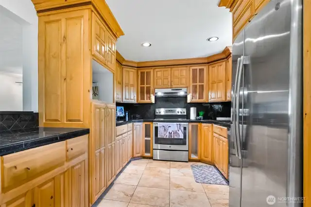 Kitchen Finishes Include Maple Cabinetry~Granite Tile Countertops & Backsplash~Stainless Steel Appliances~Ceramic Tile Flooring~