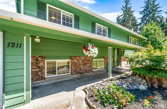 Covered Breezeway Flanked by Flower Beds~Rockery~Maple & Ivy~