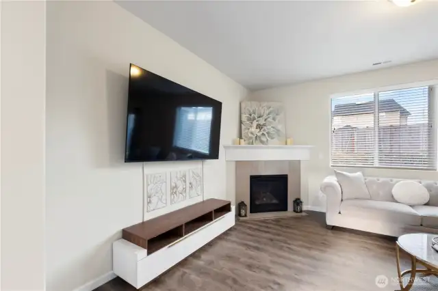 Beautifully set up living room with gas fireplace that flows into the kitchen!