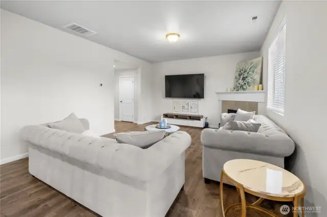 Beautifully set up living room with gas fireplace that flows into the kitchen!
