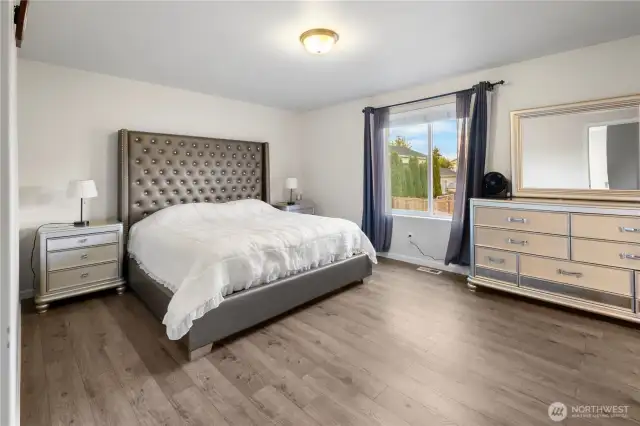 Spacious primary bedroom with a large window!