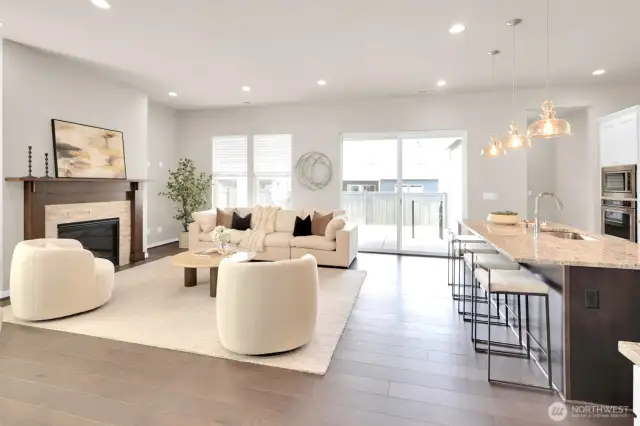Cozy up by the gas fireplace in this stylish, open-concept living area.