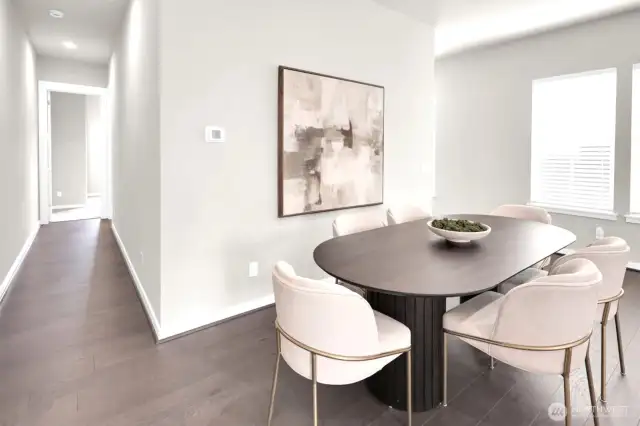 Natural light fills the living space, highlighting hardwood floors.