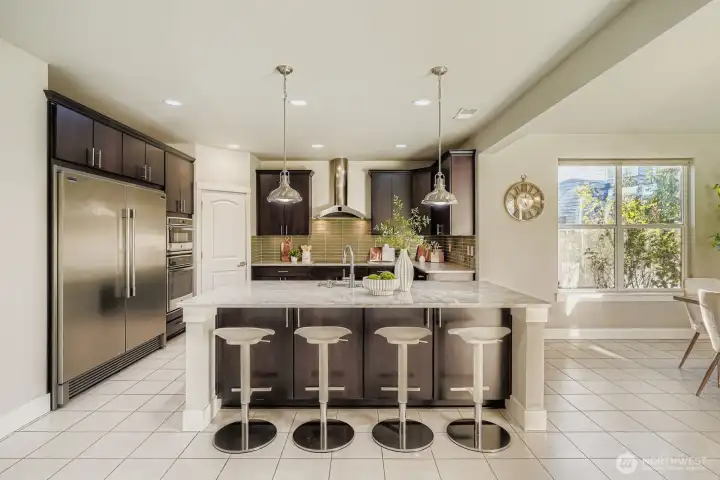 A bar to pull up a seat and entertain guests while cooking.